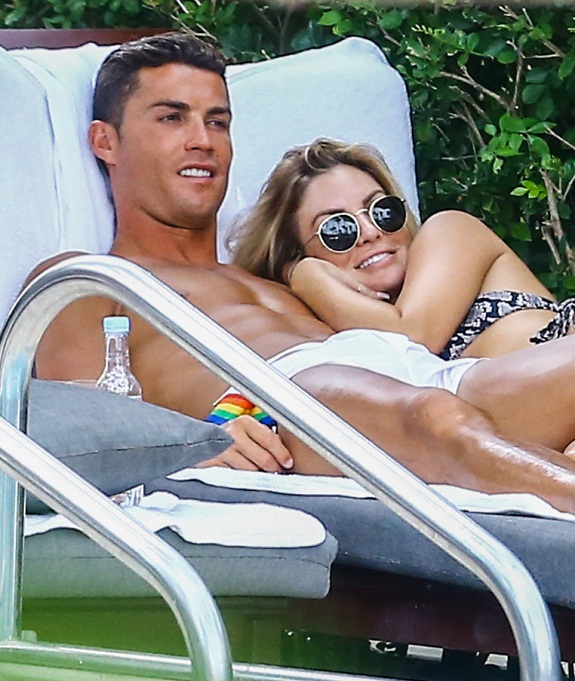 Picture Shows: Cristiano Ronaldo July 31, 2016 * Min paper Fee ¿250 * * Embargo: No web/online till 7pm UK * After 7pm ¿350 For Set * Soccer star Cristiano Ronaldo is spotted getting very close and personal with Cassandra Davis. The two cuddled by the pool together; kissing each other on the cheek and hugging constantly in Miami, Florida. At one point, one of the girls sitting next to the two got up and groped the mystery woman's butt. * Min paper Fee ¿250 * * Embargo: No web/online till 7pm UK * After 7pm ¿350 For Set * Exclusive All Rounder UK RIGHTS ONLY Pictures by : FameFlynet UK ¿ 2016 Tel : +44 (0)20 3551 5049 Email : info@fameflynet.uk.com